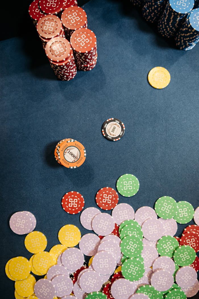 why-choose-us Colorful casino chips scattered and stacked on a gaming table, capturing the essence of gambling excitement.